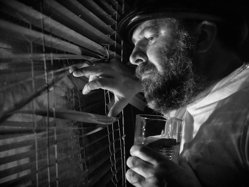 Person looking into the distance near a large bright window