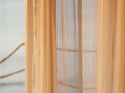 Soft light passing through white translucent window curtains